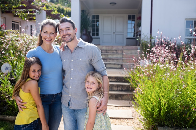 Reduce Microplastics in Your Drinking Water - Portrait of family standing together on garden path