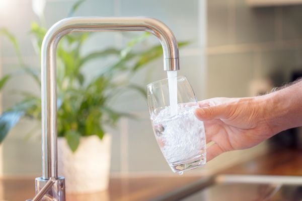 Image of water going into a cup. What's In Your Water?