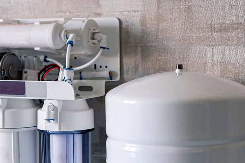 Is Your Family Exposed to "Forever Chemicals”? Your 2025 Drinking Water Guide. Photo of a water filtration system installed underneath a sink.