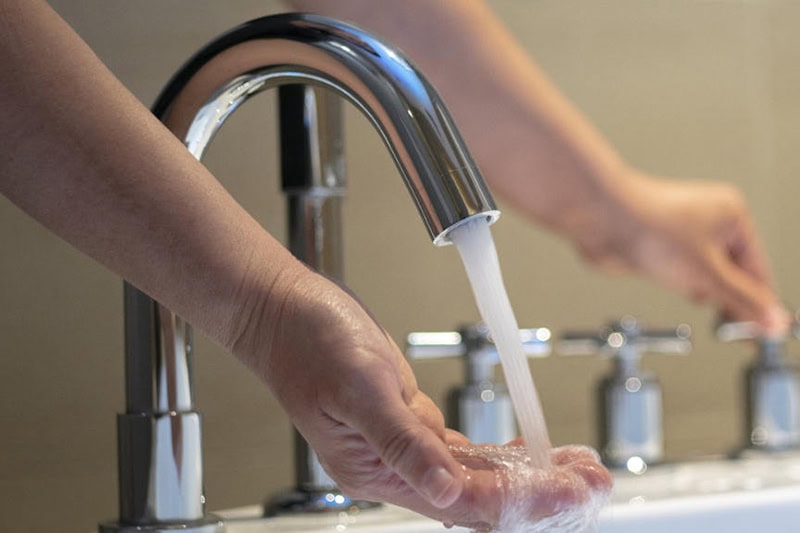turning on the water of bathtub